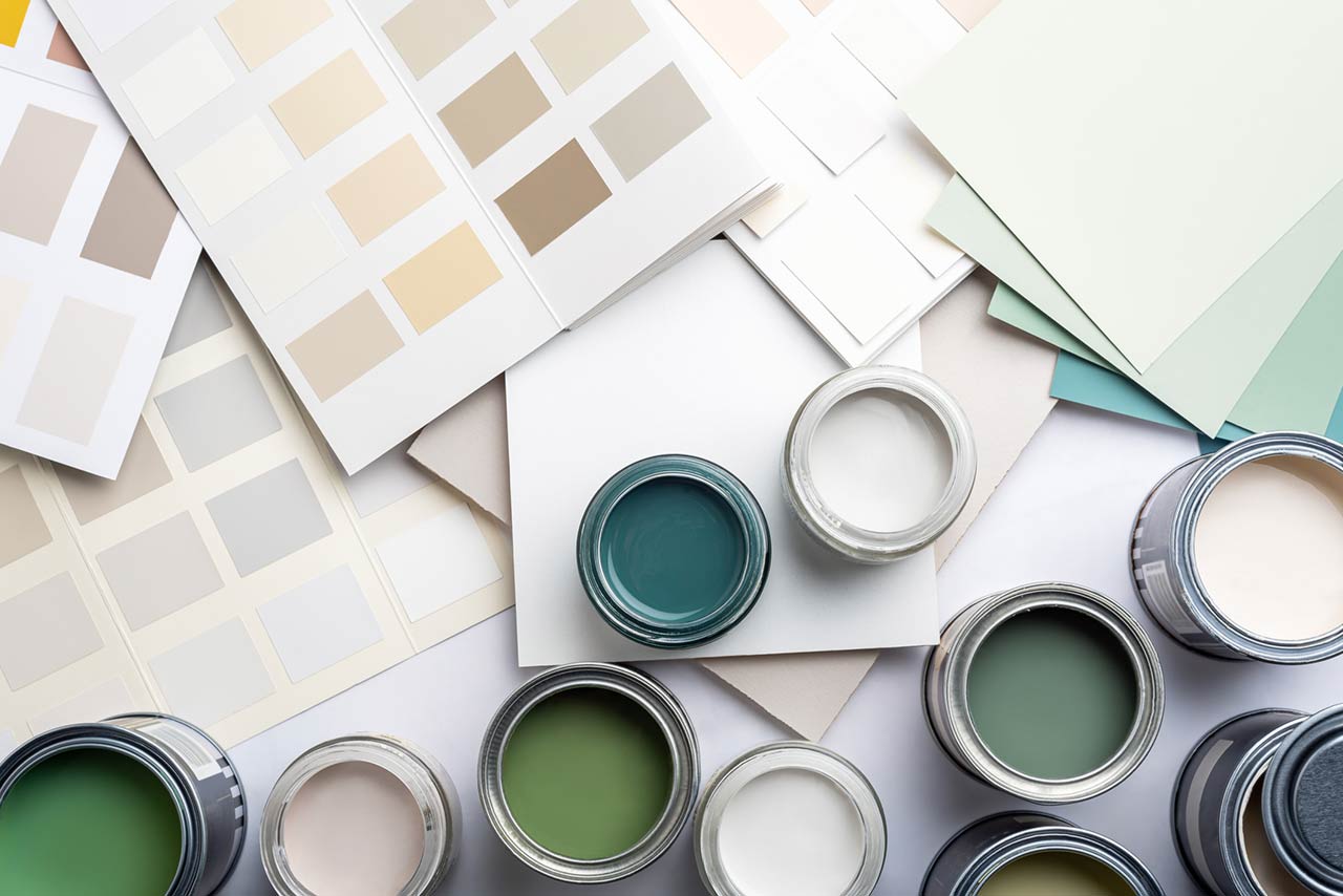 Tiny sample paint cans during house renovation, process of choosing paint for the walls