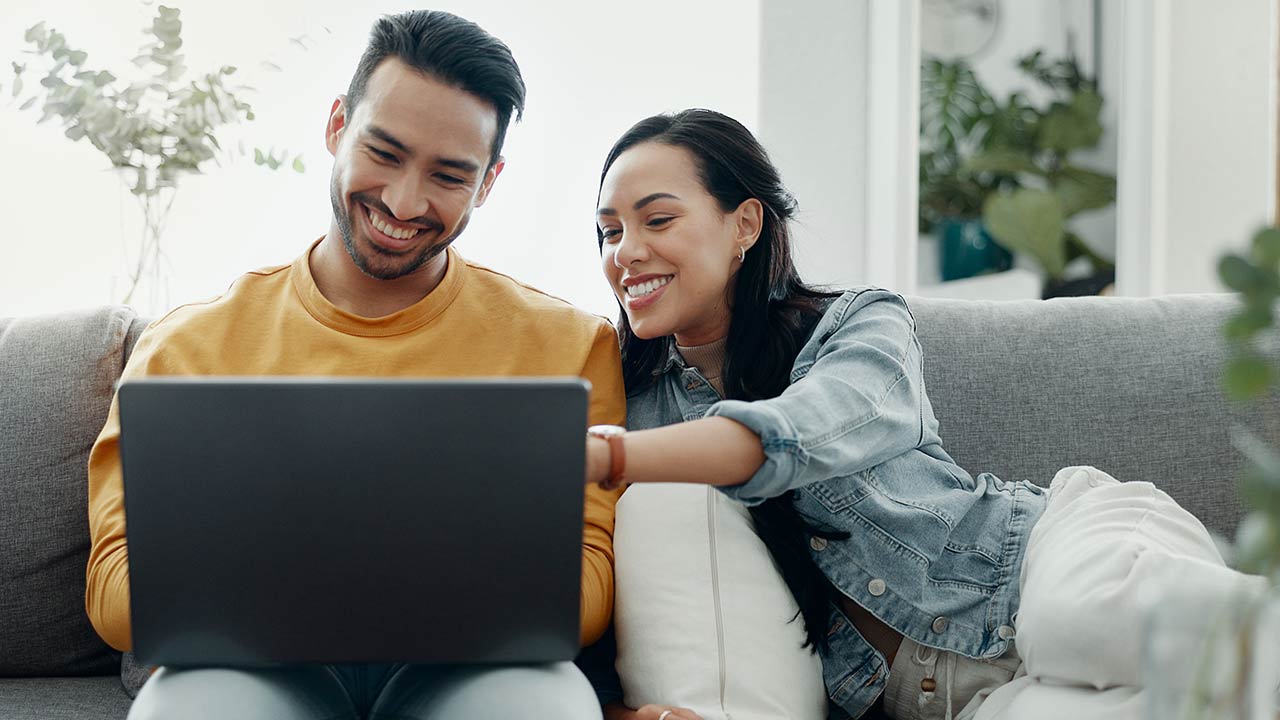 Home laptop, smile and relax couple search internet