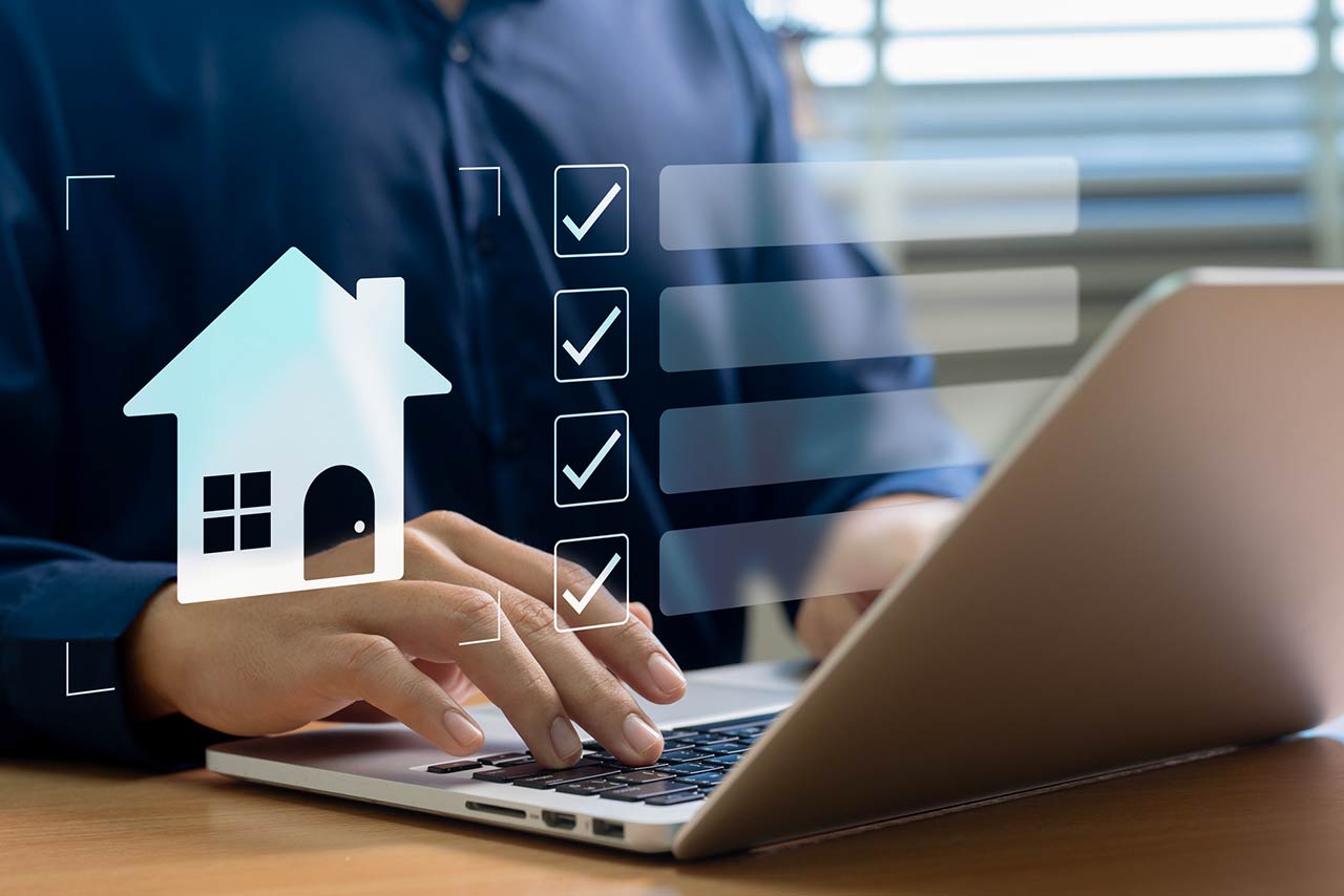 A professional organizing real estate tasks on a laptop using a digital checklist