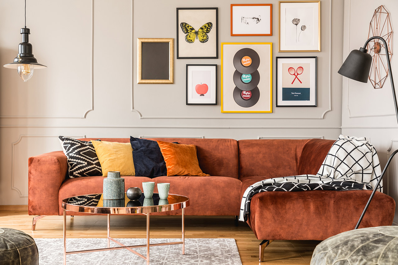 Eclectic living room interior with comfortable velvet corner sofa with pillows stock photo